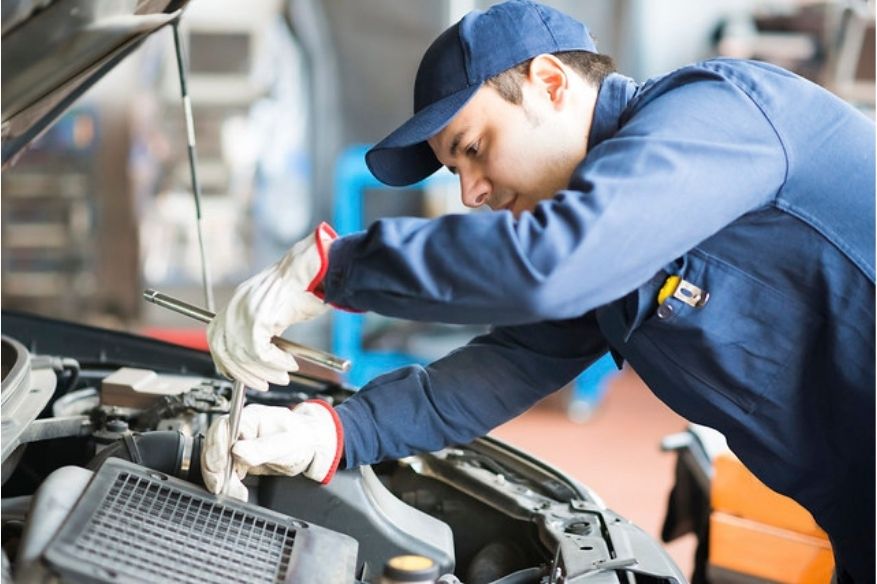 service technician working on a car