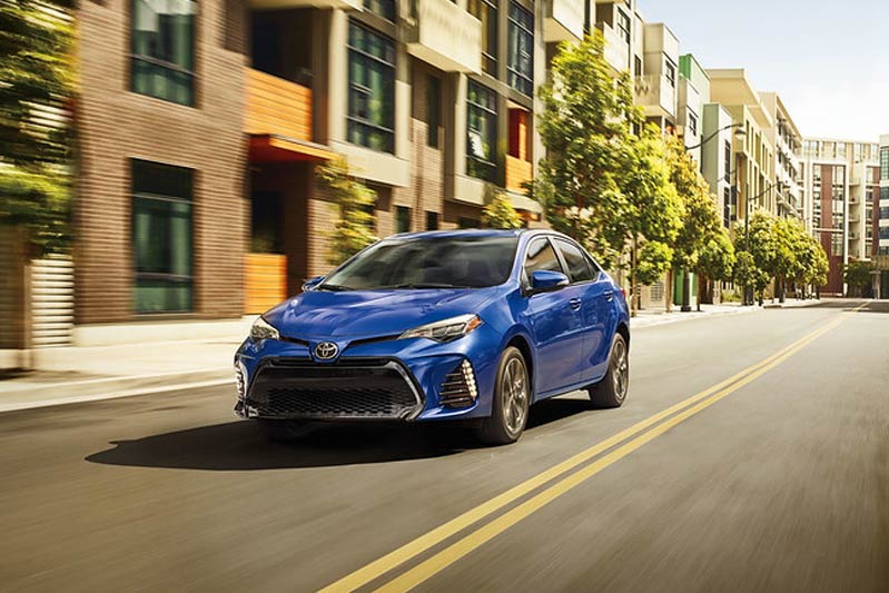 Toyota driving through the city