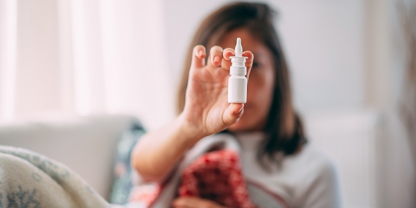 Woman holding nasal spray
