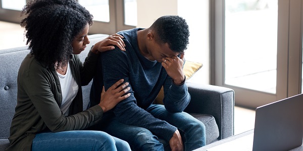 Stressed man being comforted