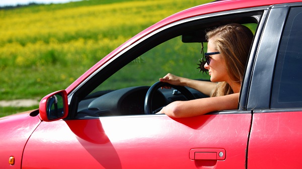 Woman driving a red car