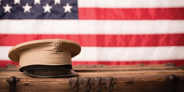 Military hat in front of an American flag