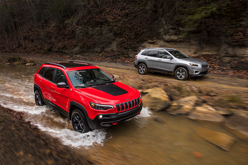 Two Jeep® Cherokees off-roading through water