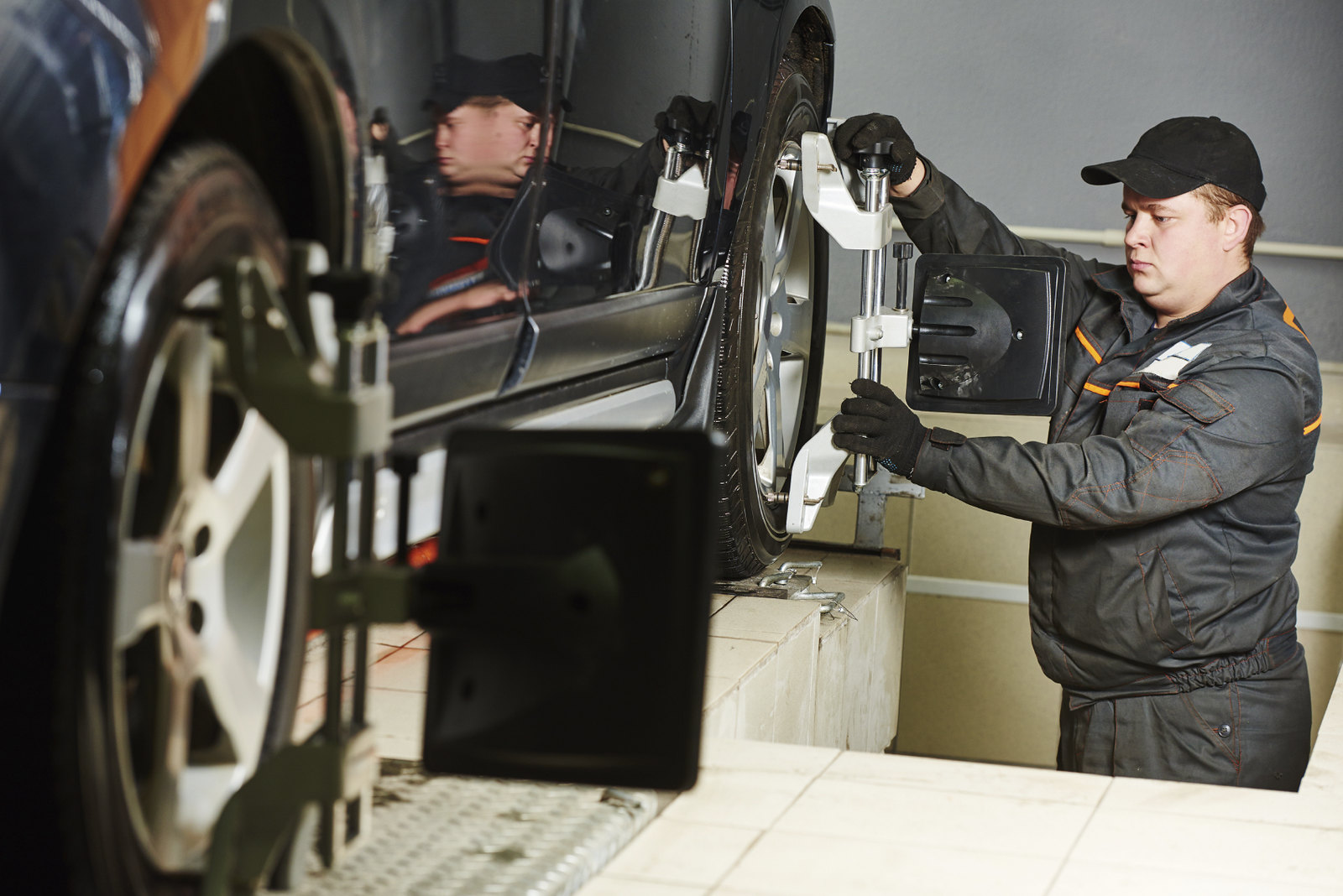 Man performing a wheel alignment